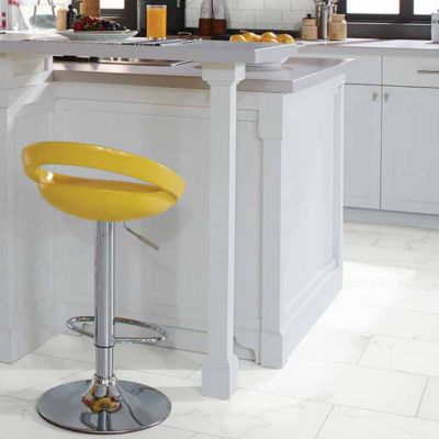 white oversized floor tiles in a bright kitchen